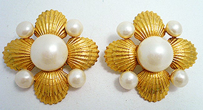 These unusual and lovely vintage signed Chanel earrings have a seashell design with faux pearls in a gold metal setting.  These clip earrings measure 2 1/8” in diameter, are signed Chanel Made in France and are in excellent condition.