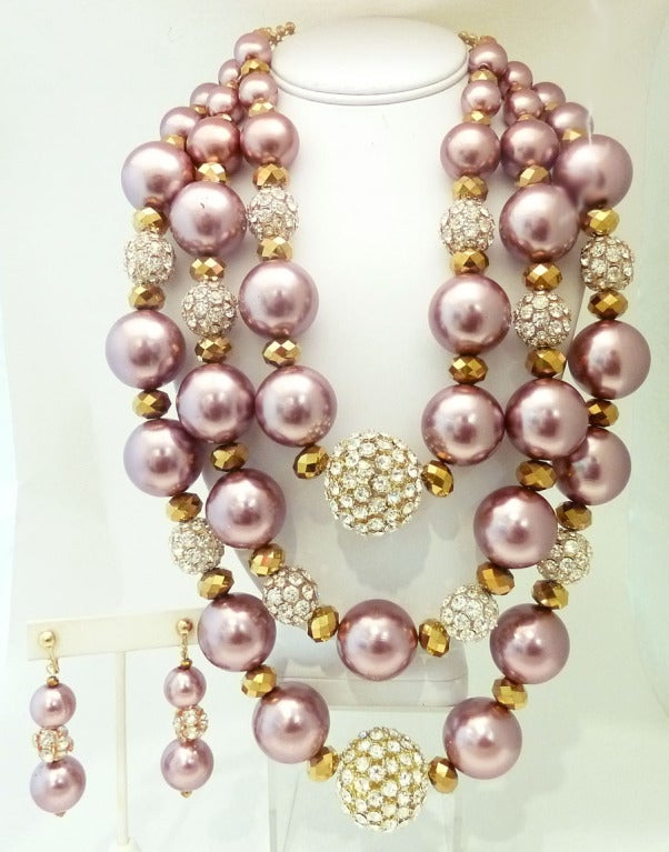 This One-of-a-Kind signed R. E. Roselli set features dark mauve color faux pearls with clear rhinestone ball accents and bezel cut champagne color resin beads in a gold-tone setting.  The necklace has an inside strand measurement of  25in with a