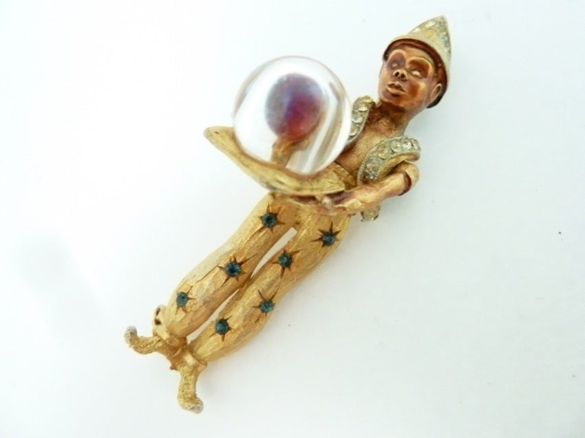 This is the famous vintage full length Har genie with a Crystal Ball by Har with blue and red rhinestones, copper-tone enameling and a large red stone within the crystal Ball.   Measuring 2 3/4” x 1” with a turn closure, this piece is signed Har and