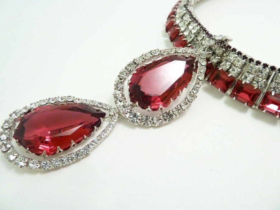 This One-of-a-Kind Signed Robert Sorrell necklace features red and clear rhinestones in a silver-tone setting.  The bottom drop pendant can be removed to shorten the accent drop.  This necklace will have a pair of matching earrings, when Robert digs