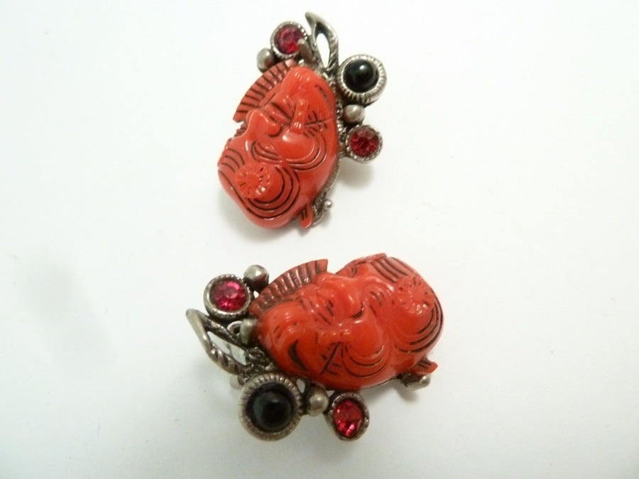 These famous vintage earrings by Selro feature the red devil design with red and black stone accents in a silver-tone setting.  In excellent condition, these clip earrings measure 1 1/8” x 7/8” and are signed Selro.