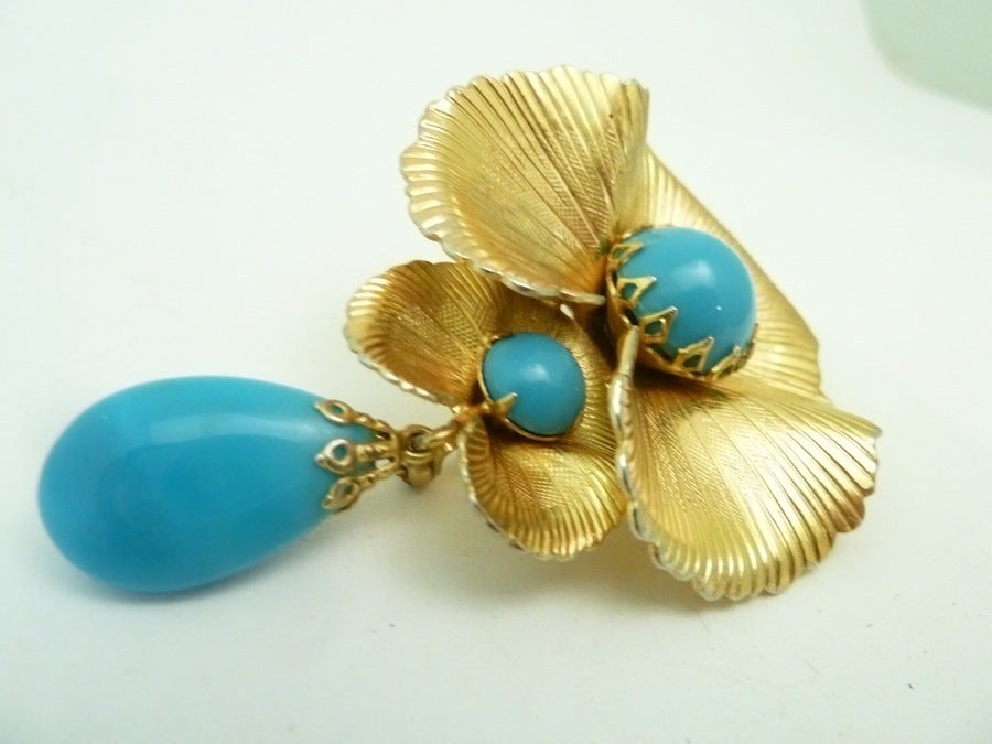 This vintage signed Scaasi pin features faux turquoise stones in a gold-tone setting. It is always difficult to find a lovely piece of Scaasi jewelry and I was very happy to find this pin.    In excellent condition, this pin measures 3” x 2” and is