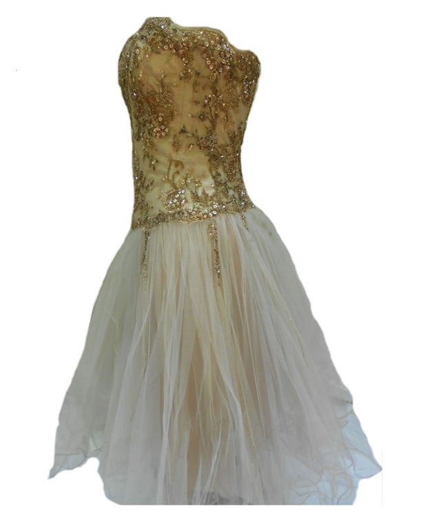 Short gold laced, corseted beaded bustier with multi-tulle circle shirt.