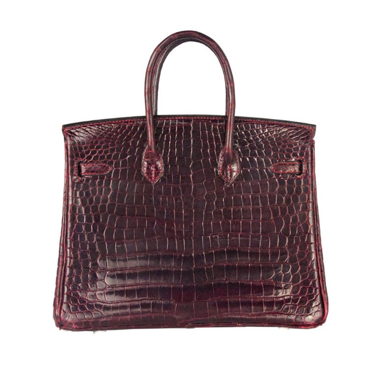 This is a cognac 25 cm Birkin bag made with Porosus Crocodile skin – commonly found on the northern shores of Australia. There is no glaze overlay, which means this bag will never peel. Instead the bag is polished with an agate stone before being