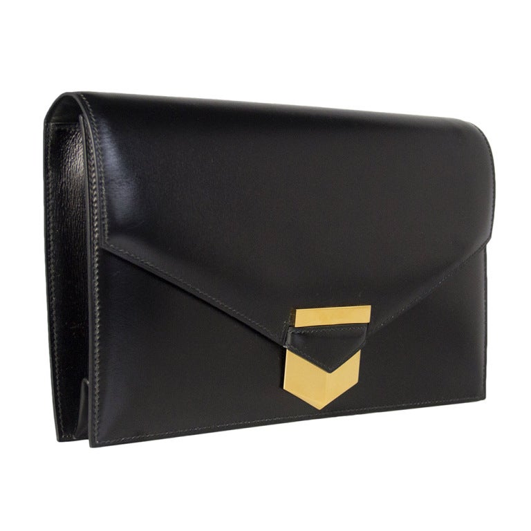 This Hermes Clutch comes in smooth box leather and features gold-tone hardware. Inside the bag there is one large zip pocket and an open front sleeve. 

Returns Policy: Final Sale - No Returns.

All of our items are shipped from the UK, as a