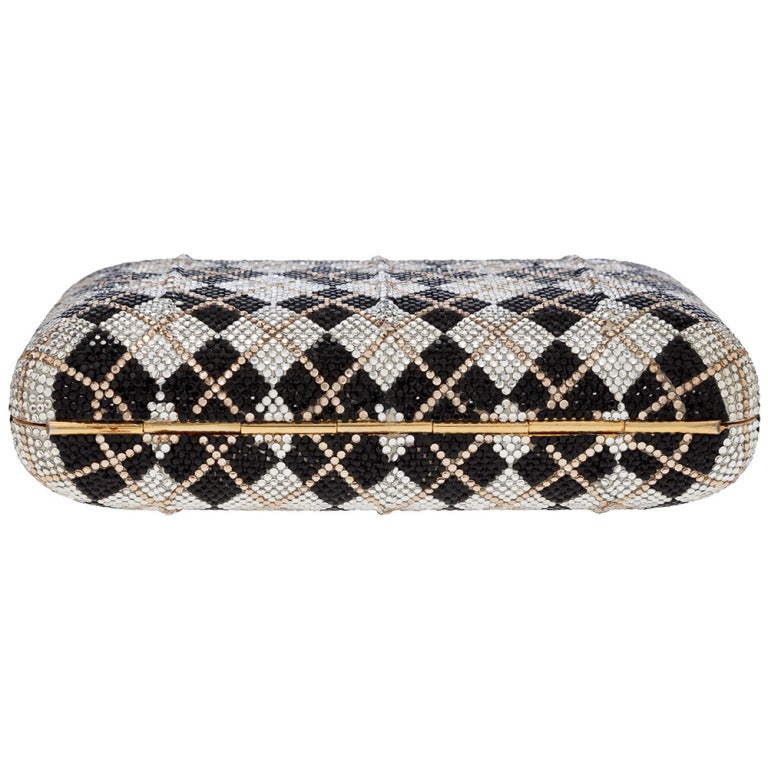 This full bead minaudiere is desgined in a rounded rectangular shape and made of Austrian crystals with gold hardware and trim and push lock clasp. Chain shoulder strap may be tucked in for added versatility.