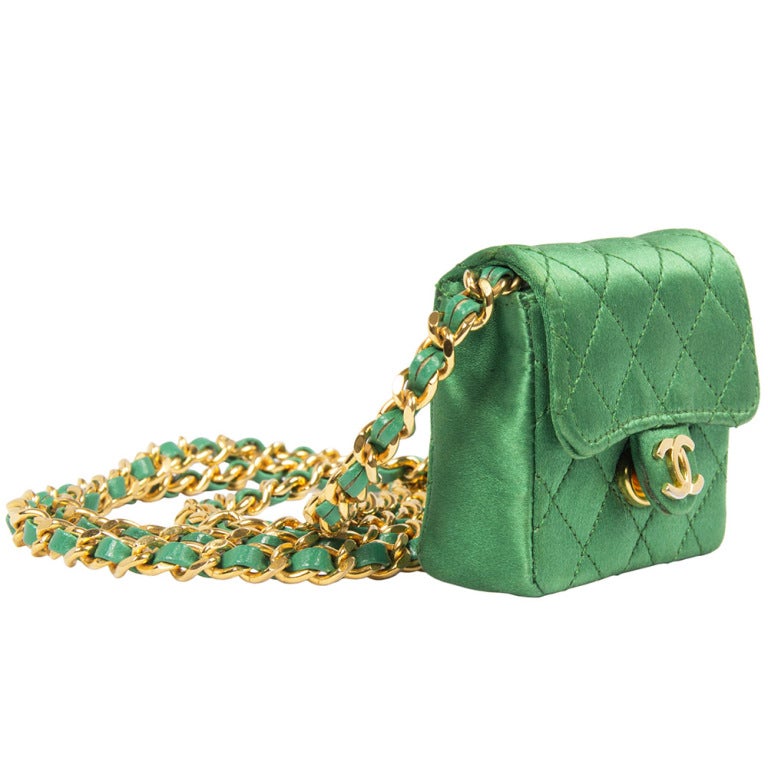 This Chanel vintage miniature classic Chanel in green satin is a very rare find. This bag features gold- plated hardware and one long, un-adjustable strap.

Colour: Green, gold

Measurements:  W: 7.5cm H: 6cm D: 2.5cm Handle Drop: 50cm 

Date: