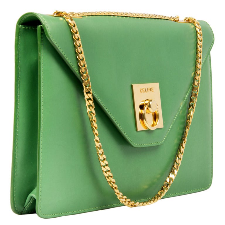 This beautiful vintage shoulder bag from Celine features apple green box leather and gold- plated hardware. The interior is lined with tan leather and has one zipped pocket.

Returns Policy: Final Sale - No Returns.

All of our items are shipped