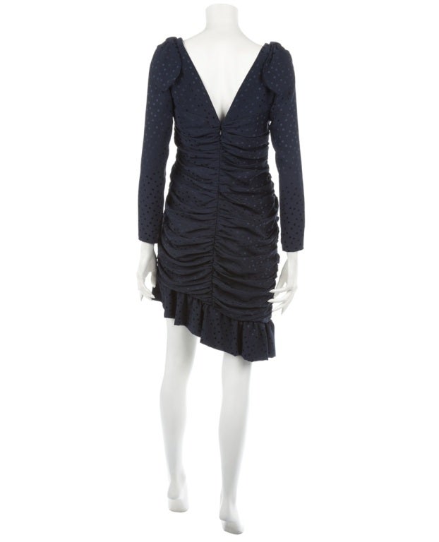 Silk dress from Loris Azzaro in a navy blue polkadot with a wide V-neck line, a ruched middle section, peaked hem with ruffles and a bow detailing on the shoulders.

Returns Policy: Final Sale - No Returns.

All of our items are shipped from the