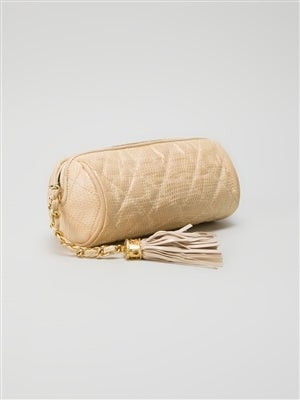 This leather make-up bag by Chanel Vintage features a top zip fastening, a gold-tone woven chain metal handle with a branded tassele, a  classic quilted pattern and a white lining with a zipped pocket. 

Material: Lizard Skin

Measurements:  W: