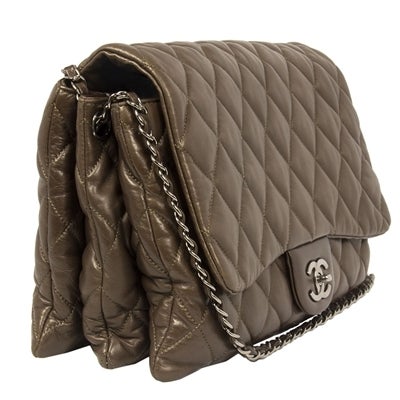 This classic Chanel Jumbo 2.55 shoulder bag is crafted in soft brown leather and boasts silver hardware. This piece has three interior compartments with brown satin lining. There is one interior zipped pocket and one exterior open