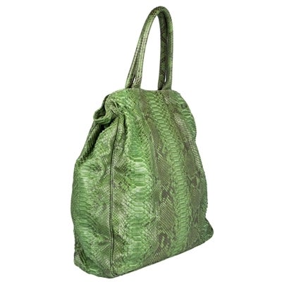 Zagliani handbag in Green Snakeskin. This piece is treated in silicone and has a magnetic closure. Interior is lined in grey suede and features one zip pocket and two open pockets.

Material: Snake skin

Measurements: height: 43cm, width: 49cm,