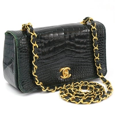 This Chanel crocodile shoulder bag is a rare collectors item from the late 1980's.  The bag features a double 'C' lock and a green leather lining. 

Material: Crocodile Leather

Measurements:  W: 19cm H:11 cm D: 6cm Handle Drop: 42cm
