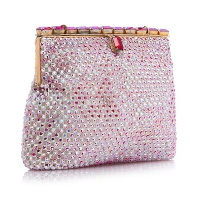 1950's rare vintage handbag in white satin covered in pink aurora borealis rhinestones. The bag is opened by pulling a red rectangular rhinestone. The interior of the bag is lined in cream satin

Material: Satin, rhinestones, gold- tone