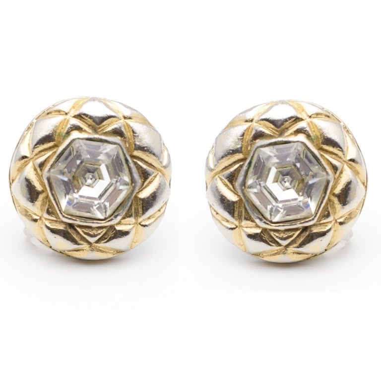 Chanel Vintage clip-on earrings, embellished with a large clear crystal and textured gold and silver hardware.

Returns Policy: Final Sale - No Returns.

All of our items are shipped from the UK, as a result you may be liable for any applicable