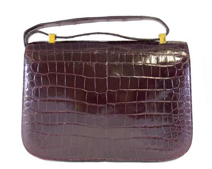 This is a 1969 ultra rare Constance bag, the first ever made Constance production.
This extremely rare crocodile skin, vintage Hermes Constance bag comes in a unique and extremely sought after burgundy colour. While most Constance bags have a