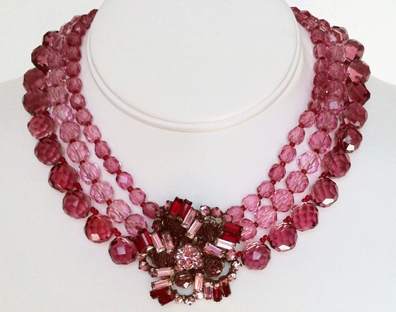 Fine vintage Miriam Haskell prototype necklace. Gorgeous signed 3 strand pink to cranberry crystal bead necklace with pendant center. Center features matching color Swarovski crystals and matching beads. Original hook closure intact.

Prototype