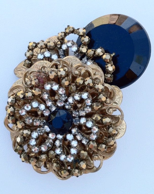 Fine vintage Miriam Haskell prototype brooch. Signed gilt metal item features 'jet' crystal with bronze and clear Swarovski crystals. Exquisite item shows great depth and charm. Original pin back intact.

Prototype item from the Robert F.