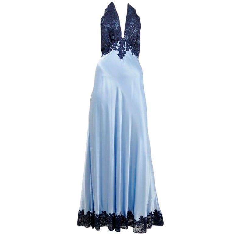 Sky blue bias cut silk satin gown with midnight blue lace at halter neckline and hem.