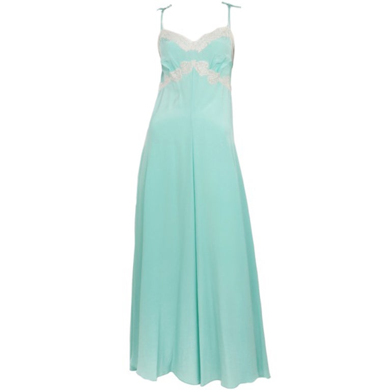 Turquoise crepe gown with cream lace at bust and neck.