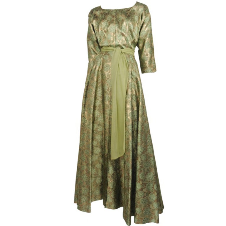 Moss green & gold lame hotess gown with chiffon sash at waist.