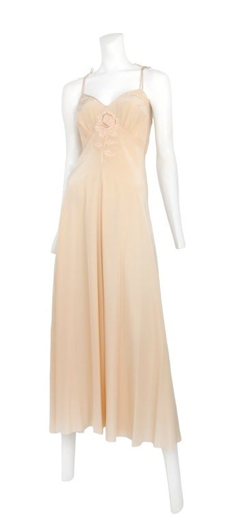 Soft peach satin robe and gown set. Robe has off white marabou feathers at collar and cuff. The gown has soft gathers at bust with a rosebud applique at center.