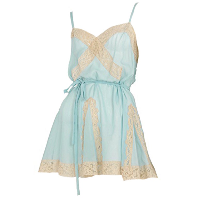 Soft blue chiffon mini dress with contrasting beige lace trim and insets. Thin sash at waist with a sweetheart neck.