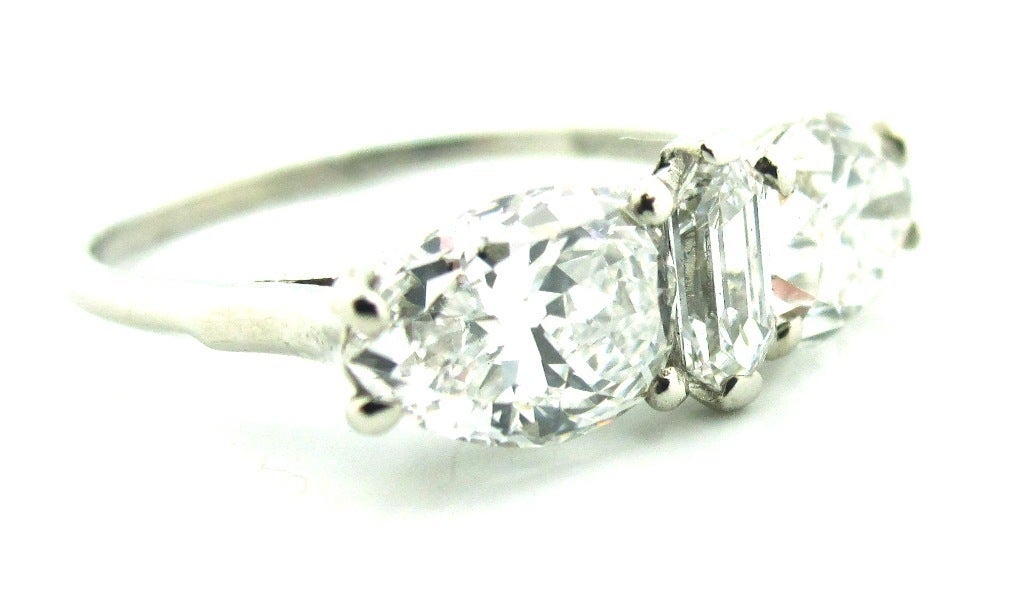 One-Of-A-Kind Art Deco era handcrafted platinum & 3-stone Old Cut diamond engagement ring by Birks Ellis Ryrie (Historically Important jewelry firm from Toronto). Composed of platinum and featuring 2 Old Cut Pear Shape diamonds. Both are GIA