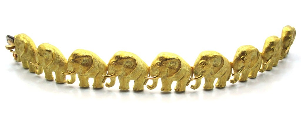 A very rare vintage elephant motif bracelet by Bulgari composed of 9 solid 18 karat yellow gold elephant links with a combination of a polished and brushed gold finish. 7 inches in length and each link is just under 1 inch in width. Pressure spring