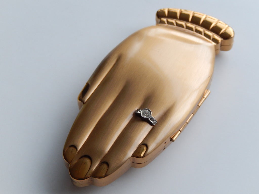 A witty forties compact by Volupte in the shape of a hand with a faux 