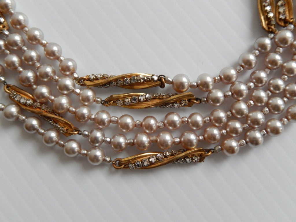 An elegant multi-strand pearl necklace with gilt metal and rhinestone spiral links---a very graceful design.

Pearl strands vary in length from approximately 16 to 20 inches.