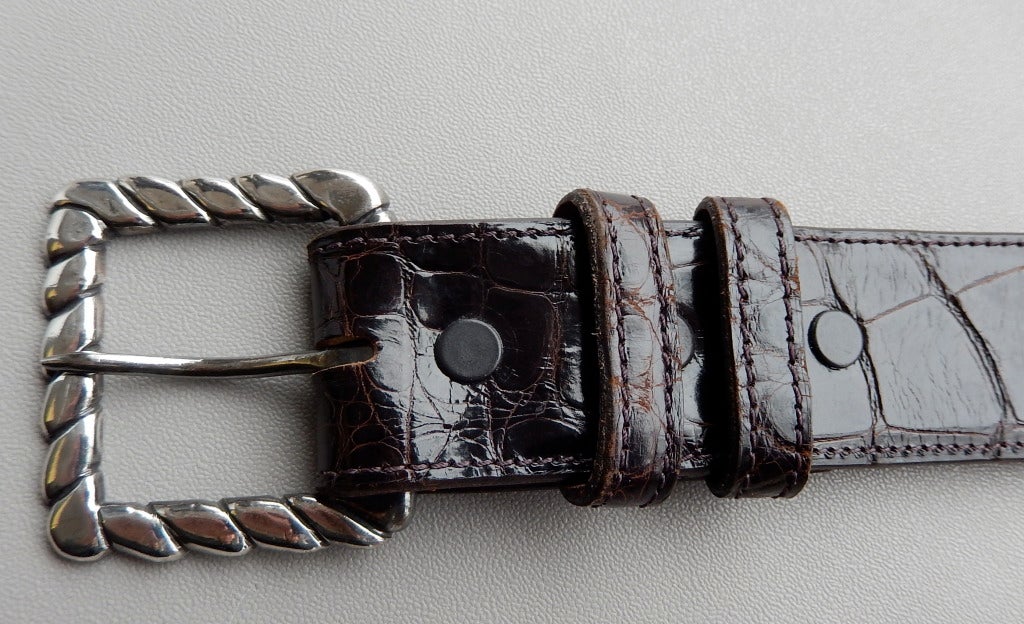 Art Deco sterling belt buckle in a twisted rope design by William Spratling.  The rich chocolate brown alligator belt was added later and is meant for a small waist.  Fully marked; dates from Spratling's early period  c. 1931-1945

Buckle:  1.75