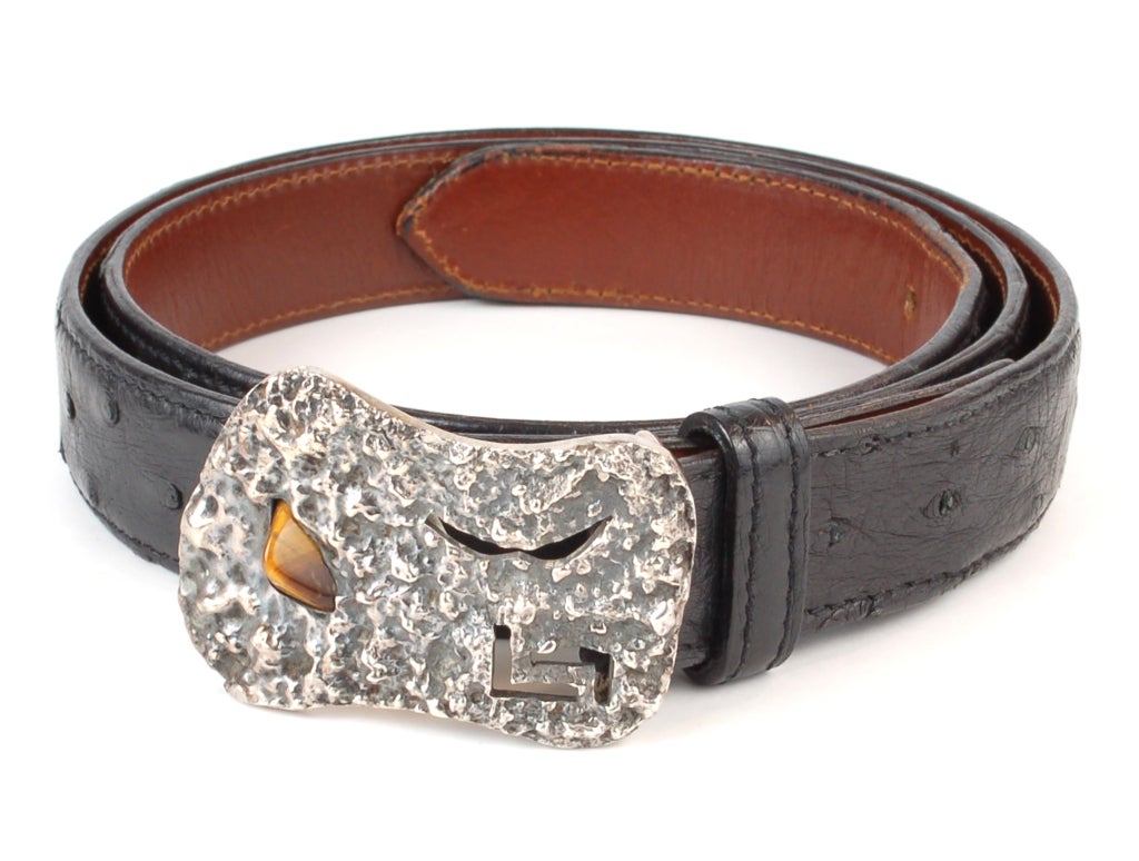 Very unique belt buckle by the great modernist master Antonio Pineda of Taxco Mexico. This buckle is unique and has a tiger's eye stone and cut out abstract designs. Shown with a leather belt for display