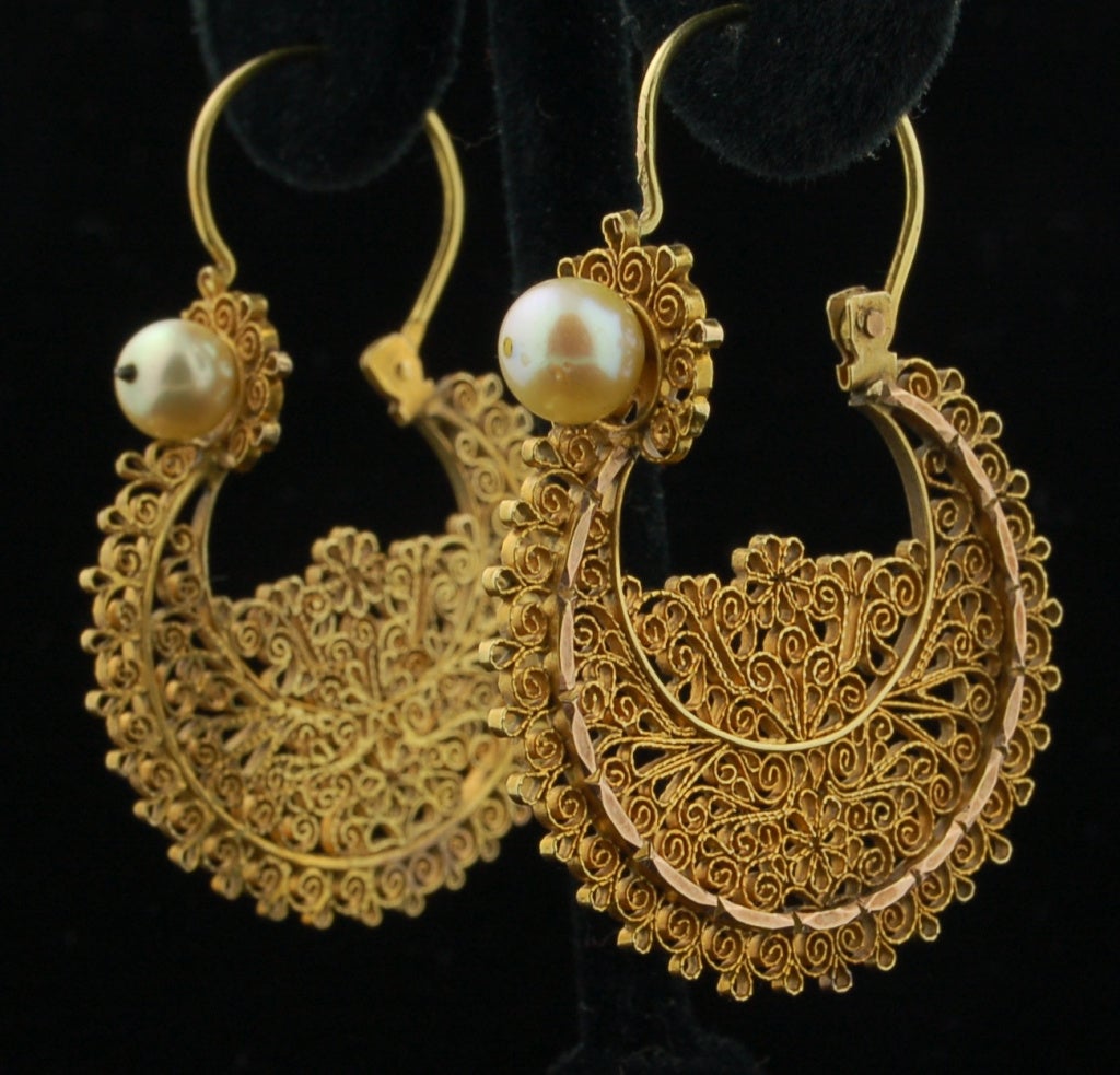 A rare find this pair of large 12k gold arracadas made probably in Oaxaca in the 19th C.  These earrings are a true heirloom.