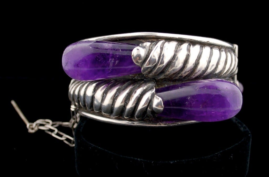 Extraordinary bracelet made in the 1930s in Taxco.  The design is Spratling' but the marks are generic for the period in Taxco.  It is very well made and with the finest repousse and large drop shaped Mexican amethyst. Has a pin closure. Finest