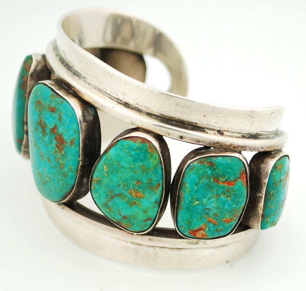 An outstanding dark green cuff bracelet.  The stones are really spectacular.  The dark aqua green color of this turquoise makes the cuff specially attractive.  This cuff would fit a medium woman's wrist. There is substantial weight to the piece but