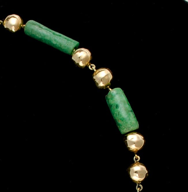This amazing necklace was crafted in the early 20th C in Mexico utilizing tubular beads of Mayan jade. The necklace is formed with 11 Mayan (Classic period ~300AD) tubular beads alternating with two solid 14k gold beads. This is a unique custom