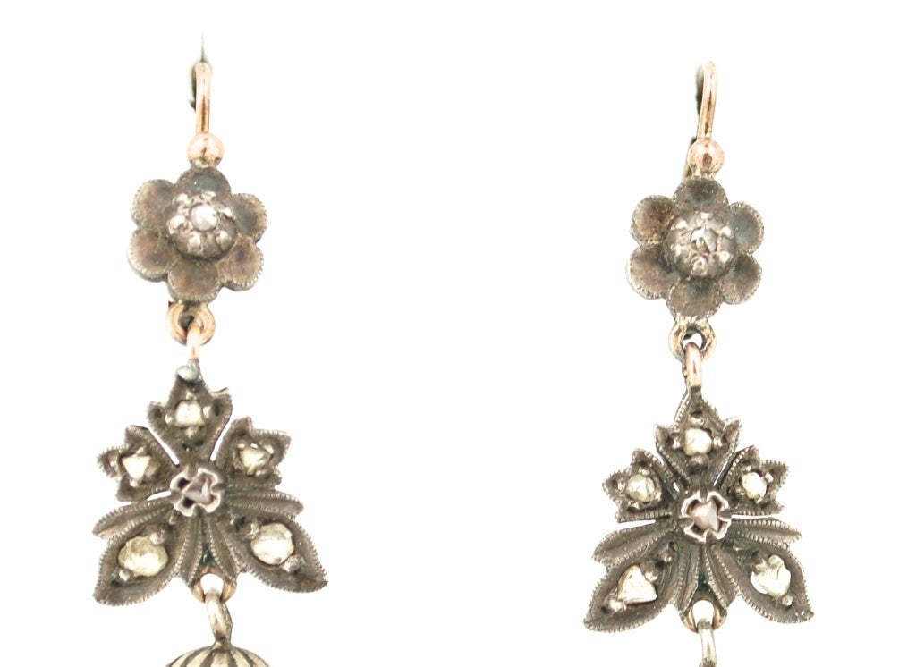 Exquisite 19th C Mexican earrings made in the Victorian style of frontal silver and red gold on the backs. The earrings have mine cut diamonds and a pendant pearl. The current pearls are contemporary replacements the rest of the earrings are all