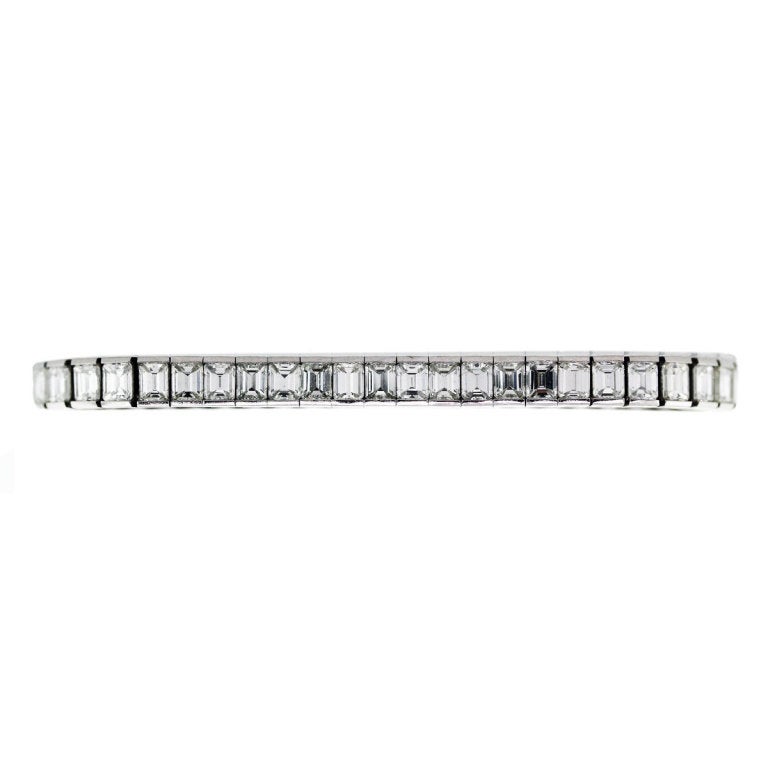 This Platinum Tennis Bracelet features approximately 13.20ctw of Emerald Cut Diamonds. The Diamonds are G/H in Color and VS in Clarity. The bracelet is 3/16