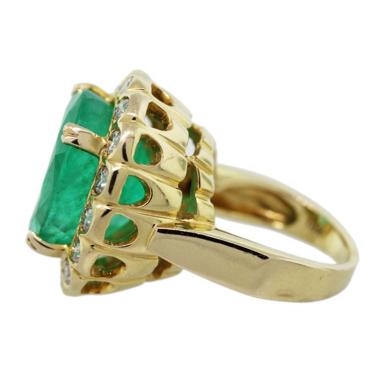 Check out this beautiful Emerald cocktail ring! 

Style: Emerald and Diamond Cocktail Ring
Metal: 18k Yellow Gold
Diamond Color: G/H
Diamond Clarity: SI
Diamond Weight: Approximately 1.44ctw (~3.5mm Diameter)
Gemstone Details: 19ct Oval Cut Emerald