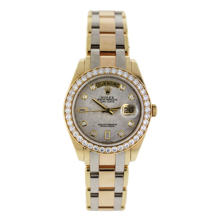Brand : Rolex
Model : Tridor Masterpiece
Reference Number : 18948
Case Measurement : 39 mm
Case Material:18K Yellow Gold
Dial :Meteorite Dial with Baguette and Round Diamond Markers
Bezel:Pave Set Diamond Bezel set in 18k Yellow Gold
Bracelet