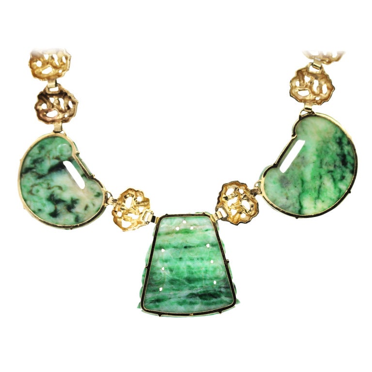 This Jade necklace is set in 14k Yellow gold. The Center Jade stone measures 2'' x 2''. The accent round Jade stones measure 2.25'' x 1.75''. The chain of this necklace measures 18''. This necklace is considered a statement necklace because of its