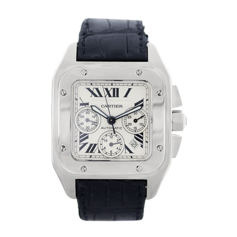 This stainless steel Cartier Santos 100 XL chronograph, Ref. W20073X8, has a case diameter of 42 mm. The bezel is  stainless steel and the dial is white with black Roman numerals. The leather strap has a stainless steel double-deployant buckle. This
