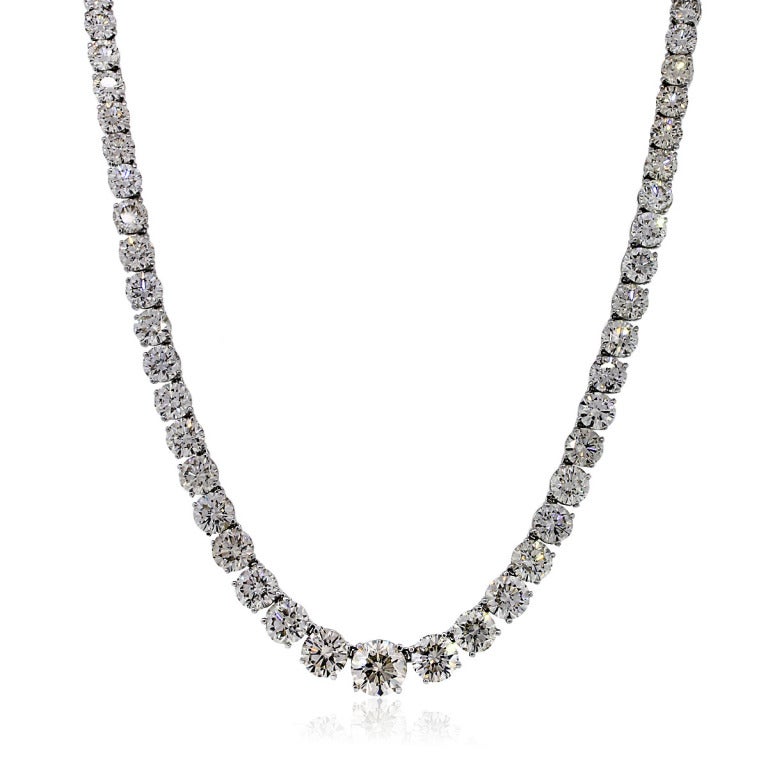 Tennis Necklace measures 15.5'' in Length, Diamonds, Approximately 50.94ctw of Round Diamonds. Diamond Color is L/M and Clarity is SI2/I1. The Total Weight of this item is 38.9 grams or 25.0 Pennyweights. The Clasp is a Tongue and Box with Safely