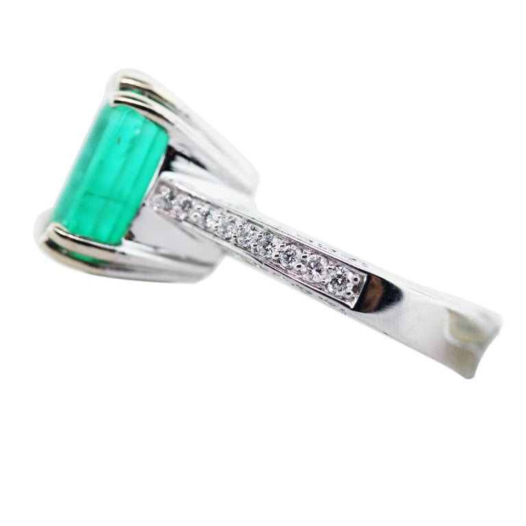 Beautiful Emerald and Diamond Cocktail Ring in 14K White Gold.  Emerald measures 11.48mm x 11.33mm.  Large Size Stone, setting is set with approximately 0.40ctw.  Diamonds are G/H in color VS in clarity.  Ring size is 6.5