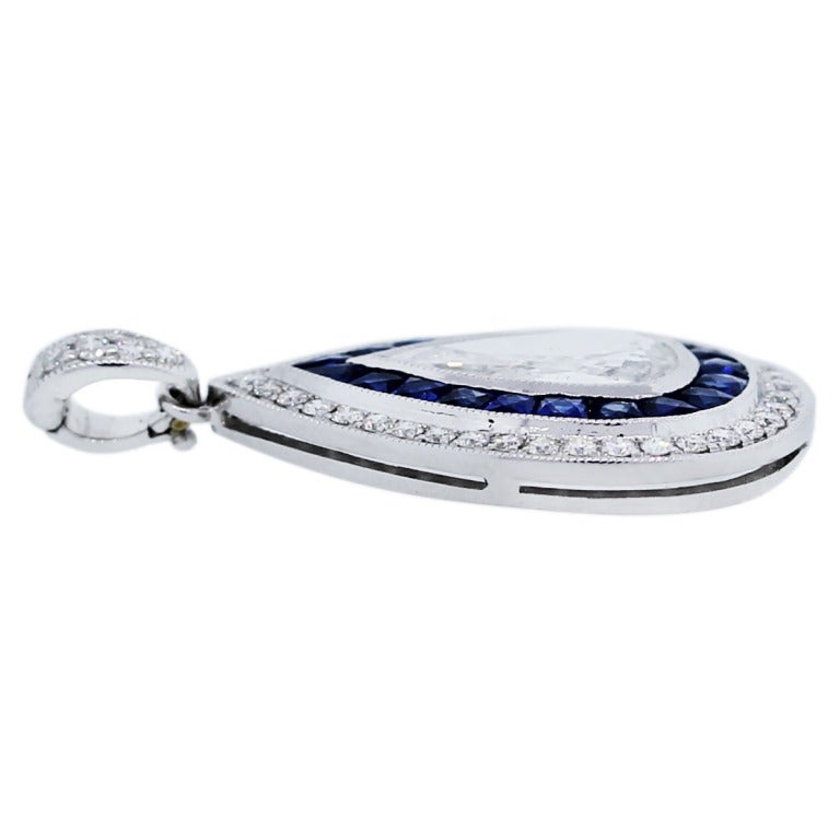 Natural Sapphire & Diamond Halo Pendant Platinum In Stock

This Natural Sapphire & Diamond Halo Pendant in platinum features a stunning central diamond surrounded by a dazzling sapphire and diamond halo. The pendant exudes elegance and