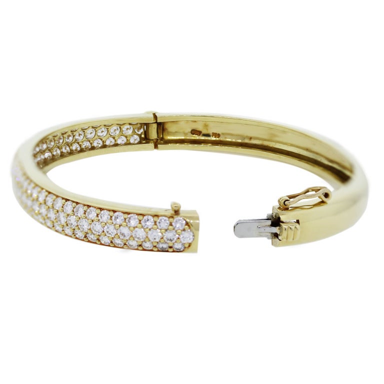 Style: 18kt Yellow Gold Round Cut Diamond Bangle Bracelet. Material: 18K Yellow Gold. Diamond Details: Approximately 5ctw of Diamonds. Diamonds are G/H in Color and VS in Clarity. Total Weight: 25.7g (16.5dwt). Bracelet Details: Bracelet will fit a