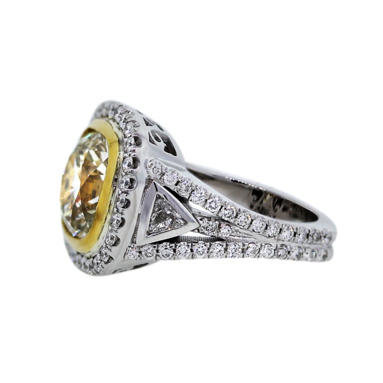 Style: 18k Two Tone 4.62ct Cushion Cut Fancy Yellow Diamond Engagement Ring
Main Diamond: 4.62ct Cushion Cut
Diamond Color: Fancy Yellow Color
Diamond Clarity: SI2 in Clarity
Mounting Details: Cushion Cut Diamond is Set in an 18k Yellow/White
