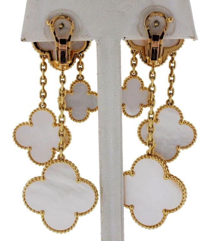 Designer: Van Cleef & Arpels
Collection: Magic Alhambra 
Style: Drop Dangle Earrings 
Earring Material: 18k Yellow Gold
Earring Measurements: 3'' 
Gemstones: Clover Shaped Mother of Pearl 
Retail Value: 11,900