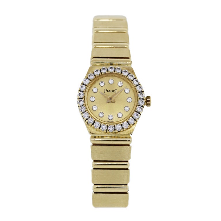 Company: Piaget
Model: Lady's Polo Mini
Case Material:	18K Yellow Gold
Case Measurement: 20mm
Bracelet: 18K Yellow Gold
Dial:	Gilt with Diamond Hour Markers
Bezel: Diamond-set, F/G in color and VS in clarity
Movement: Quartz
Crystal: Scratch